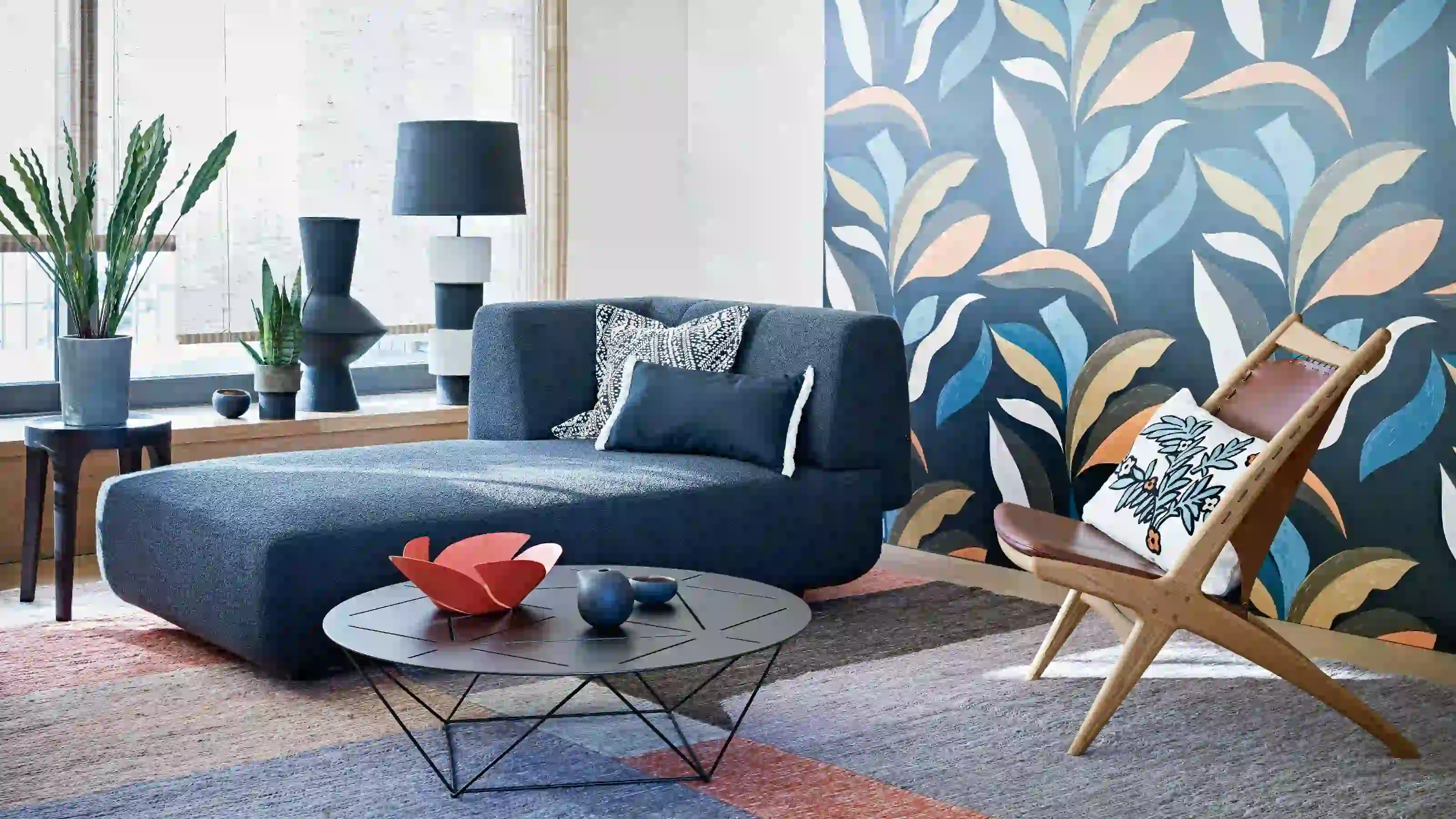 Botanical wallpaper behind a contemporary living room seating area
